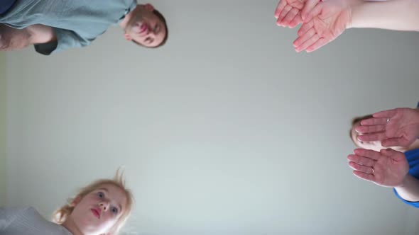 A Friendly Large Family Makes a Circle Shape Out of the Palms of Their Hands.