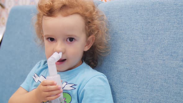 Little Child Makes Inhalation with Nebulizer. Close Up