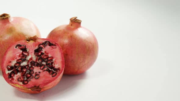 Pomegranate with half piece on white background 4K 4k