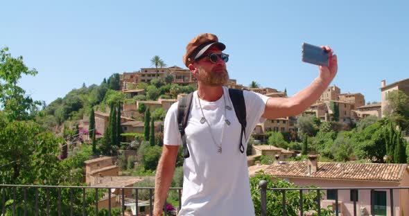 Happy traveler taking selfie in old town