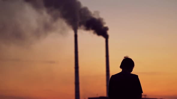 Silhouette of a person with phone at sunset.