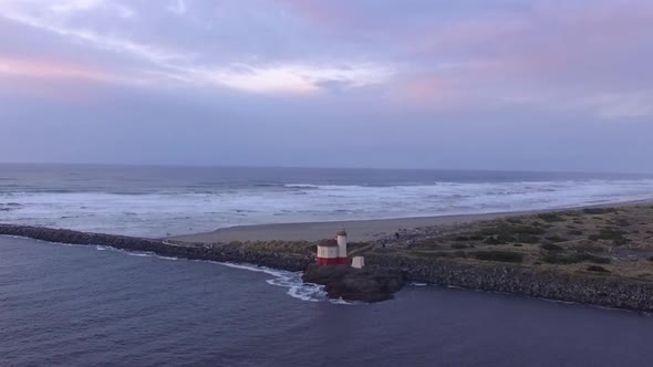 Coquille River lighthouse drone footage taken during sunset, where Pacific Ocean meets the Oregon co