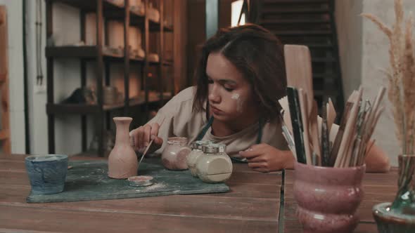 Female Artist Painting Ceramic Vase