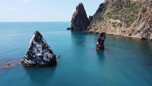 Aerial View From Above on Azure Sea and Volcanic Rocky Shores