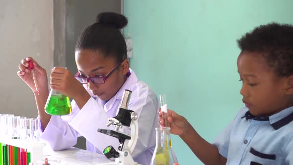 Two African American Mixed Kids Testing Chemistry Lab Experiment