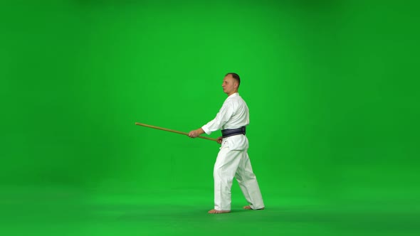 Masculine Kendo Master on White Kimono Warrior Practicing Martial Art with the Bamboo Bokken on