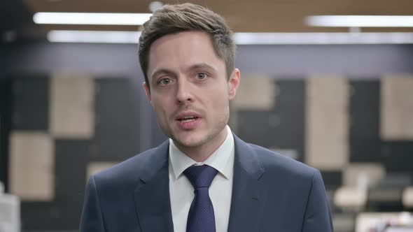 Portrait of Businessman Talking on Online Video Call