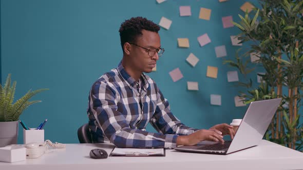 Exhausted Person Giving Thumbs Up and Putting Forehead on Desk