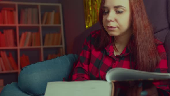 A Beautiful Student Reading a Big Book