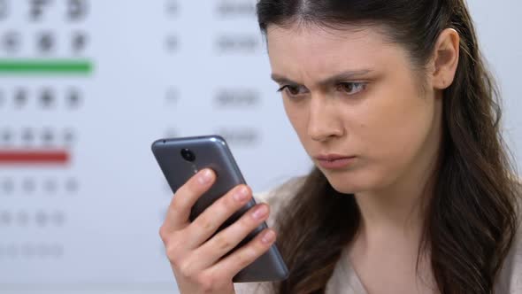 Woman in Ophthalmology Clinic Checking Diagnosis Through Internet, Online Doctor