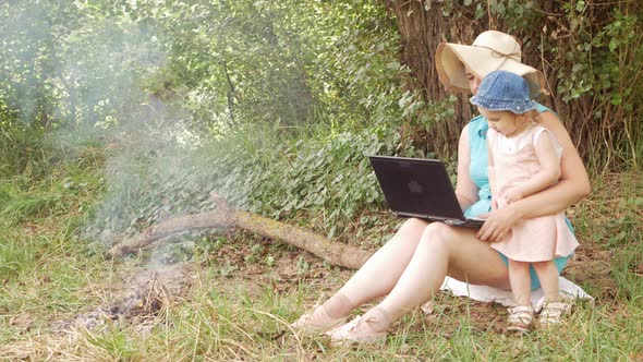 Mother and Daughter Rest in the Forest Communicate with Friends Video Link