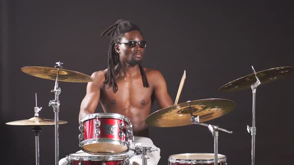 Professional African Drummer Man Playing on Drums and Cymbals