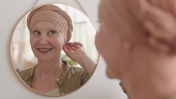 Smiling Lady in Headscarf Looking in Mirror