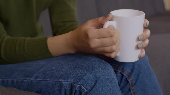 Close Up Shot of Female Hands Holding Cup of Hot Tea Warming Palms Slow Motion
