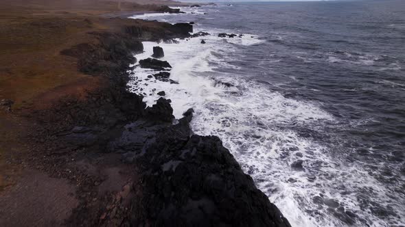 Drone Flight Over Rocky Coastline With Surging White Surf