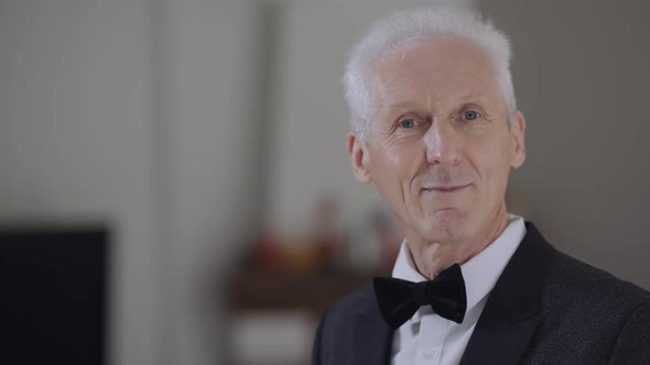 Portrait of Happy Senior Groom Turning Looking at Camera Smiling in Slow Motion Standing on the