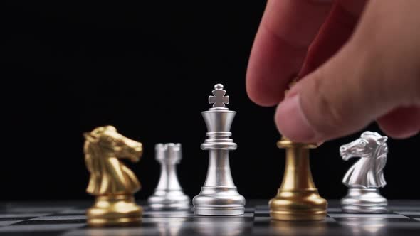 Close up of male hand moving gold king chess for defeating opponent, Game of Chess. Leader and Teamw