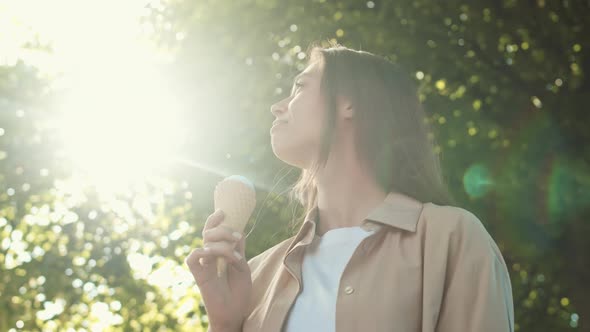 Happy Woman with Icecream in Park