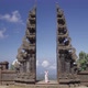 Woman in White Dress Praying Standing in Famous Bali Gates Historical Sacred Sightseeing in - VideoHive Item for Sale