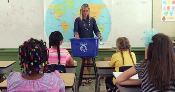 Teacher in front of class giving recycling lesson