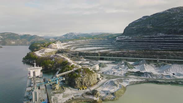 Aerial of Quarry beside the sea. Ship loading on pit.Rock Mine. Mining industry