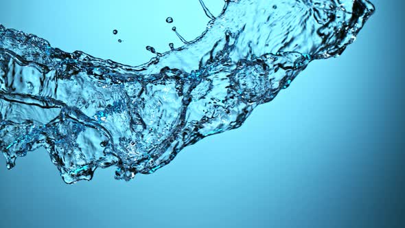 Super Slow Motion Shot of Water Splash on Blue Gradient Background at 1000Fps alt