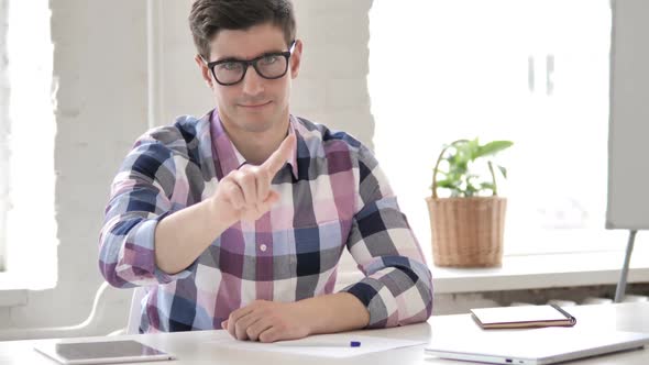 No By Young Man in Office Looking at Camera Denial