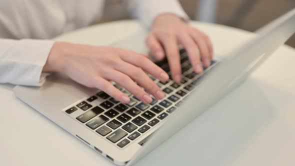 Woman Typing on Laptop Keyboard Top View