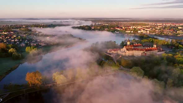 Amazing Dawn in the Foggy Nesvizh, Fog Over the River. Nesvizh. Ancient Castle . Belarus