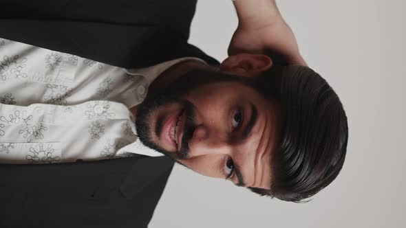 Portrait of a Brutal Breaded Man Adjusting His Hairstyle and Shirt Vertical Slowmotion