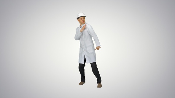 Funny scientinst in white robe and safety helmet dancing