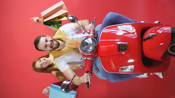 Happy Beautiful Couple on a Motorcycle Bought Gifts, the Woman Has a Bunch of Gift Bags in Her Hands