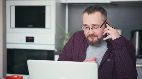 An Adult Handsome Bearded Man Working From Home