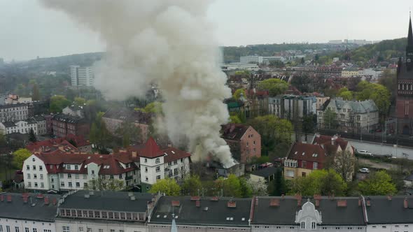 Aerial View of a City with a Fire and a Column of Smoke From the Fire
