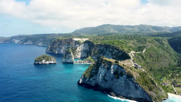 Fly Around Cliff and Rocks Over Ocean Along Coast