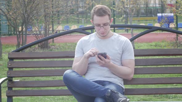 Man Uses A Modern Smartphone