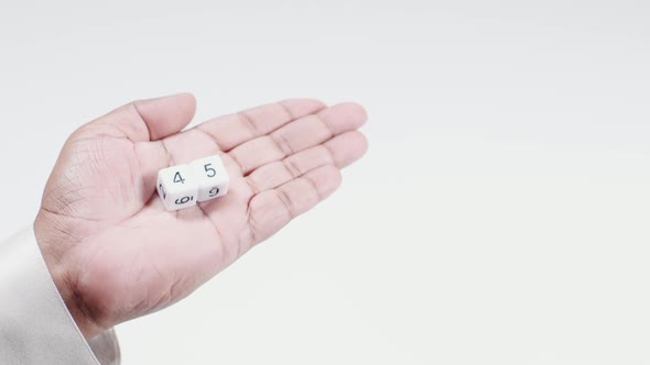 Hand Holds Numbered Dice   Four And Five Forty Five