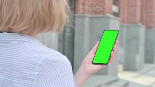 Woman Using Smartphone with Green Chroma Screen