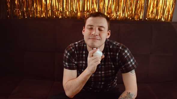 Young Man Using 3d Massager for Face