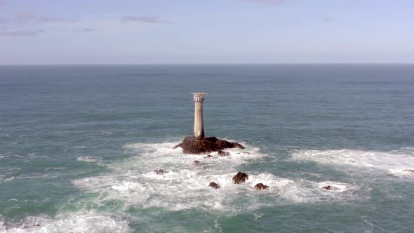 Isolated Lighthouse at Sea on a Rock During the Summer