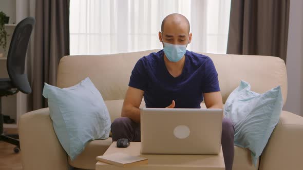 Man with Protection Mask on a Business Video Call