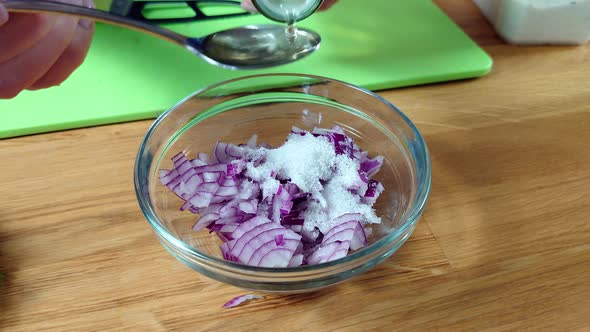 Woman Preparing Marinade for Red and White Onions in Jar