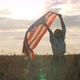 Happy Patriotic Young Woman Waves the US Flag Into the Field - VideoHive Item for Sale