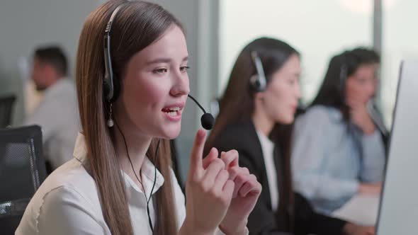 Close Up Portrait Woman of a Technical Customer Support Specialist Talking on a Headset While