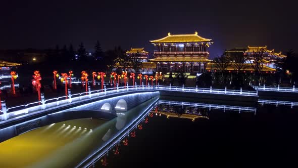 A Fascinating View of a Chinese Pagoda and a Place Sparkling with Night Lights That are Reflected in