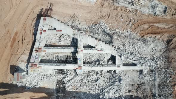 AERIAL: Fallen Construct of National Stadium in Vilnius with Steel Bars and Cement Piles nearby