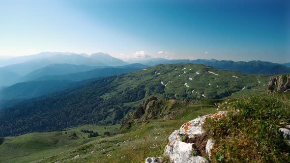 Morning View From Stone of Beautiful Green Valley with Wild Forest and Mountain Silhouettes in Sunny