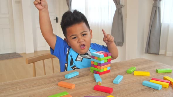 Little Boy Dancing With Color Wood Block Tower Game