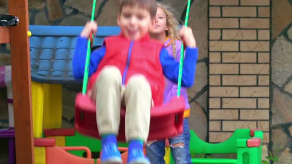 Pushing Brother on Swing 