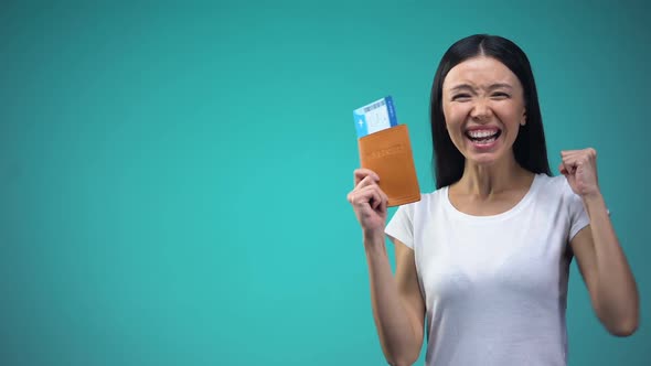Excited Woman Holding Passport With Tickets in Hand, Winning Vacation Tour